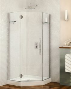 a bathroom with a corner shower and wooden floors