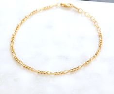 Simple ready to wear modern layering bracelets in 14k Gold filled. ✦ Quantity: 1 chain ✦ Material: 14K Gold filled ✦ Dimensions: 6.5 inches with 1 inch extender Wheat Chain Width: 2.9mm Figaro Chain Width: 2.2mm Flat Chain Width: 2.3mm ✦ Surface: shiny gold Ships next business day. ✦✦ SAVE 15% over $75+ CODE: SAVE15✦✦ Please let us know if you are interested in a higher quantity than what is currently listed. *International customers will be responsible for Import duties, taxes, since these are Adjustable Gold Figaro Chain Bracelet, Adjustable Figaro Chain Gold Bracelet, Adjustable Figaro Chain Bracelet As Gift, Adjustable Figaro Chain Bracelet For Gift, Adjustable Gold Figaro Chain Bracelet As Gift, Layering Bracelets, Rough Gems, Amethyst Gold, Figaro Chain