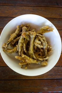 air fryer chicken feet for dogs in a white bowl on a wooden table with text overlay