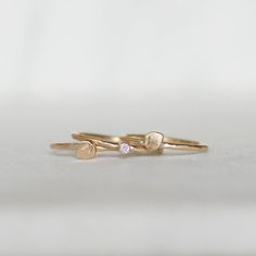 Diamond petal stacking rings in 14k gold. Sweet little handmade petals and a tiny sparkly diamond on hammered bands. Details: *Bands - Choose 1.3mm OR 1.6mm *Diamond - 2mm white - conflict-free *Gold - Eco-friendly, recycled Made to order. Production time 2-3 weeks...this does not include the time it will take to ship your ring to you. Thanks for looking! Lilian Delicate Stackable Rings In Recycled Gold For Gifts, Delicate Stackable Rings In Recycled Gold As A Gift, Delicate Stackable Rings As A Gift In Recycled Gold, Delicate Gold Stackable Rings With Gemstones, Stackable Rings In Recycled Gold, Delicate Stackable Rings With Rose Cut Diamonds For Gifts, Delicate Stackable Rings In Recycled Gold For Anniversary, Delicate Recycled Gold Stackable Rings For Anniversary, Delicate Gold Stackable Birthstone Ring