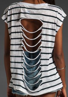 the back of a woman's shirt that has cutouts on it and is white with black stripes