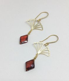 "Lovely gold Vermeil earrings with red Cubic Zirconia (CZ). These earrings evoke the romantic style of a bygone era known as the 1920's where Art Deco design was all the rage! The Vermeil fan shape is both feminine and stylish with a clear red CZ gemstone that is faceted and cut into a diamond shape that enhances its pure red color! Simply stunning, you will not go unnoticed while wearing these beauties. Perfect for your next holiday event or any other occasion. These earrings are light weight a Classic Brass Jewelry For Party, Ornate Red Dangle Earrings, Red Filigree Dangle Jewelry, Red Dangle Filigree Jewelry, Art Deco Filigree Jewelry For Gift, Art Deco Filigree Jewelry As Gift, Handmade Gold Earrings For Christmas, Handmade Gold Christmas Earrings, Elegant Christmas Jewelry With Matching Earrings