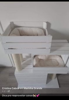 a cat bed made out of pallets and other items in the shape of a house