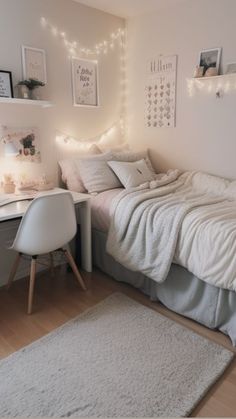 a small bedroom with a bed, desk and lights on the wall above it's headboard