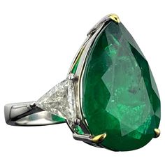 A gorgeous, Emerald and Diamond three-stone engagement ring. With a 10.97 carat pear shape Emerald in the centre, with 2 pieces 1.01 carat trillion shape White Diamonds on the side. The Emerald is of Zambian origin, with a beautiful vivid green color, transparent and amazing luster, all set in solid 18K White Gold. The ring is currently sized at US 5.5, can be resized. Customization available. We provide free shipping, we accept returns! Please feel free to message for more information. Luxury Trillion Cut Emerald Ring For Formal Occasions, Classic Trillion Cut Emerald Ring For Formal Occasions, Classic Formal Trillion Cut Emerald Ring, Gia Certified Teardrop Diamond Ring For Formal Occasions, Luxury Pear-shaped Emerald Ring For Formal Occasions, Formal Gia Certified Teardrop Diamond Ring, Formal Pear-shaped Emerald Ring In White Gold, Luxury Pear-shaped Brilliant Cut Emerald Ring, Formal Green Pear-shaped Diamond Ring