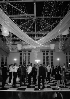 black and white photo of people dancing on the dance floor