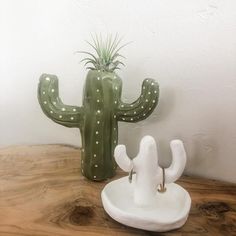 a ceramic cactus sitting on top of a wooden table