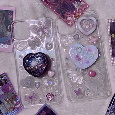 two clear cases filled with different items on a table next to cards and pictures,