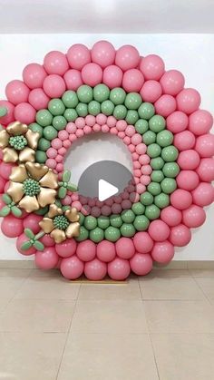 a giant balloon wreath with balloons and bows