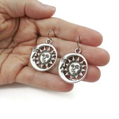 Free shipping Canada & USA with $35 purchase. Unique sun and moon celestial statement earrings. - Assembled with pure titanium ear wires (G1). Titanium is 100% hypoallergenic and will not produce skin irritation or discoloration. - Tibetan style alloy pendant measuring 30 x 26mm (cadmium free, nickel free & lead free) - Silicone stoppers included. Celestial Dangle Earrings For Everyday, Celestial Style Dangle Earrings For Everyday, Everyday Celestial Dangle Earrings, Celestial Moon Shaped Metal Earrings, Celestial Moon-shaped Metal Earrings, Nickel-free Adjustable Moon-shaped Jewelry, Nickel-free Adjustable Moon Shaped Jewelry, Celestial Drop Earrings For Everyday, Sterling Silver Celestial Earrings For Everyday