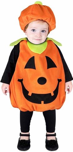 a small child dressed in a pumpkin costume