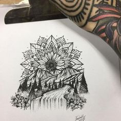 a drawing of a sunflower on top of a piece of paper with mountains in the background