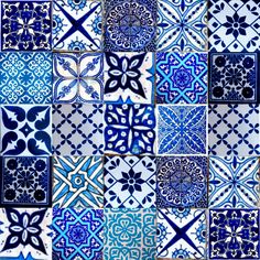 blue and white tiles with different designs on them