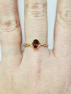 "Thanks for shopping our vintage estate store. We tend to sell well below wholesale and truly hope you enjoy all of our items. Many of the items are one of a kind, so please enjoy scrolling through the pictures and hopefully something will catch your eye. Brown spots are from reflections. Estate 10k yellow gold natural .50ct garnet midi or birthstone ring. Ring size: 7 Setting: 6mm by 4mm 1/4\" Band width: 1mm Weight: 1.0 gram Beautiful ring. Marked 10k." Oval 14k Gold Birthstone Ring Gift, 14k Gold Oval Birthstone Ring As Gift, Oval 14k Gold Birthstone Ring As A Gift, Classic Oval Ruby Ring, Vintage Oval Birthstone Ring As A Collectible, Vintage Oval Birthstone Ring Collectible, Oval Dainty Birthstone Ring For Anniversary, Dainty Oval Birthstone Ring For Anniversary, Classic 14k Gold Birthstone Ring Collectible