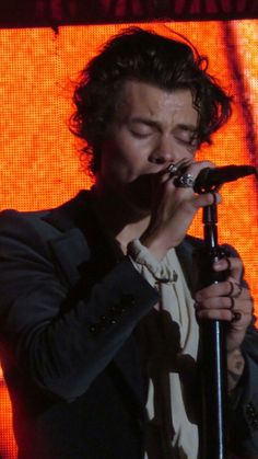 a man in a suit singing into a microphone