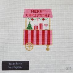 a cross stitch christmas card with a red and white cart