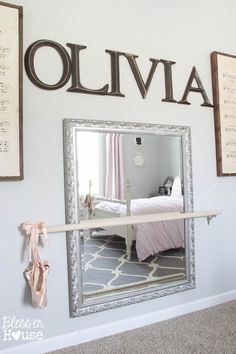 a mirror hanging on the wall above a bed