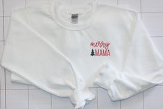 "This super comfy crewneck sweatshirt is perfect for the holiday season! On the left chest, the text \"merry mama\" is embroidered with a dark green tree. These adult unisex sweatshirts are 50% cotton, 50% polyester. Please see size chart to determine the best size. This listing is for 1 sweatshirt. Are you looking for an item that is not listed? Please send me a message and let's see if we can create your item! Thank you for browsing my shop!Find us on Facebook! All items are made in a smoke-fr Comfy Crewneck, Monogram Sweatshirt, Embroidered Monogram, Collared Sweatshirt, Embroidered Crewneck, Green Tree, Gildan Sweatshirts, Star Gift, Custom Sweatshirts