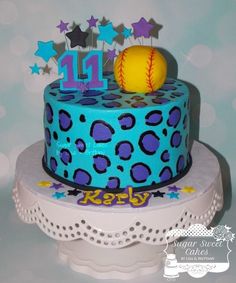 a blue and purple birthday cake with a baseball on top