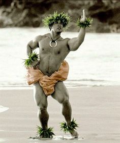 a man standing on top of a beach next to the ocean holding two plants in his hands