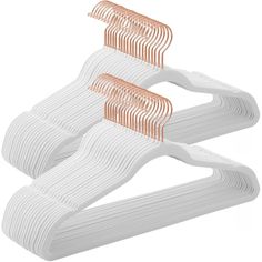 three white plastic hangers with copper pins