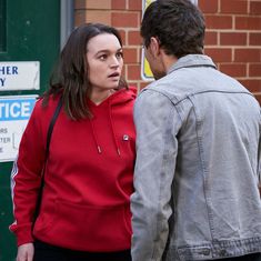 a man standing next to a woman in front of a building