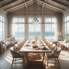 a dining room table set with place settings in front of large windows overlooking the ocean