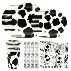 black and white party supplies including plates, napkins, forks and cups with cow designs