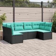 an outdoor sectional sofa set with pillows on the back and sides, in front of a brick patio