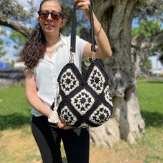 I knitted this stylish and stylish bag for you with crochet in my hand. With the black and white details of the bag, you can easily use it in any outfit you want. It is a large enough bag to put all your belongings in it for daily use or going to a garden party, going to school or going to work.     You can choose the one you like from these 4 bags in different sizes and you can write to me if there is anything you want to change.     You can gift these hand knitted bags to the people you love. Granny Square Crochet Bag, Square Crochet Bag, Sac Granny Square, Bohemian Style Bag, Hand Knit Bag, Vintage Style Bag, Black And White Bags, Bag Pattern Free, Granny Square Bag