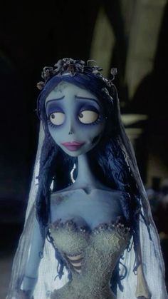 the corpse bride doll is dressed up in her wedding dress and veil, with an evil look on her face