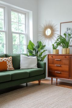 a living room with a green couch and some plants on the side table in front of it