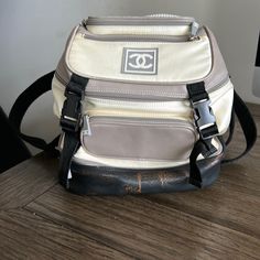 Pre Owned Chanel Nylon/Leather Sport Backpack. Authentic With Authenticity Card And Number. Good Condition. Some Staining Around The One Zipper, Very Small Amount Of Wear On The Piping Around Pockets. Leather Bottom Has Some Browning. Some Discoloration And Some Spots On Nylon. Smoke Free Home. Mini Backpack. Measures Around 9.5in Across The Base And Stands Around 9.5in Tall. Sport Backpack, Chanel Vintage, Backpack Sport, Vintage Chanel, Mini Backpack, Browning, Chanel Bag, Piping, The One