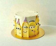 there is a yellow cake with three faces on it