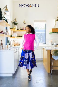 Winter outfits don’t have to be boring. You can even infuse bright color into a business casual style. Pair a vibrant pink vest with our blue African print midi skirt and you can make this skirt work every month of the year. For winter, add knee-length boots and a fancy coat. Wear this fun mix to anything from work to a Christmas party - you can't go wrong! Check out more African fashion from NeoBantu! African Print Midi Skirt, Blue African Print, Fancy Coat, Business Casual Style, Colorful Office