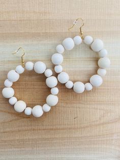 These lovely white beaded hoop earrings are in an alternating style with 8mm and 12mm wooden beads. Incredibly lightweight and versatile! Due to the beads being made of natural wood, each bead is unique with its own lovely characteristics. All earrings are shipped in a square jewelry box for safe shipping and beautiful gift giving. Artisan White Round Beaded Earrings, White Beaded Hoop Earrings For Beach, Wooden Beaded Earrings For Beach, White Jewelry With Round Wooden Beads, Nickel-free White Beaded Earrings For Beach, Square Jewelry, Beach Earrings, Summer Earring, Beaded Hoop Earrings