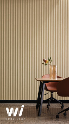 a table with a vase on it next to a brown chair and window blinds in the background