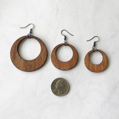 "★ Wood Hoop Earrings ★ Size choices: * Large - 1.5\" * Small - 1\" All wooden hoops come with fish hook earwire made of alloy metal (lead, cadmium & nickel free) These simple wooden earrings are a classic hoop shape that never go out of style. They are made out of stained birch wood and work with every outfit. Every piece of wood is different, the grain in your jewelry may differ slightly from the wood in the photograph. Water resistant. Not recommended to wear in shower. ★ SHIPPING * All p Nickel-free Brown Hoop Jewelry, Brown Hoop Jewelry With Ear Wire, Hypoallergenic Brown Round Earrings, Brown Hoop Earrings Gift, Brown Small Hoop Earrings With Ear Wire, Brown Hoop Earrings With Ear Wire, Brown Hoop Single Earring, Brown Single Hoop Earring, Brown Round Hoop Earrings For Gift