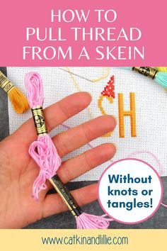 a hand holding a needle with the words how to pull thread from a skein