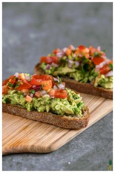 two slices of bread with avocado and tomatoes on them