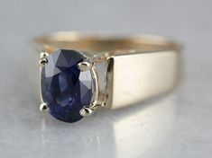 "This modern yellow gold ring has an excellent sense of structure. Well, proportioned prongs rise from the center, holding a bright blue, oval cut sapphire securely in the center. This piece would stack well with other rings and is substantial enough to wear alone as an engagement or cocktail piece! Metal: 14K Yellow Gold Gem: Sapphire 2.26 Carats Gem Measurements: 5.8 x 8.4 mm, Oval Ring Size: 7 Marks: \"T&C 14K\" Stamped on the inside band SKU #: FTZX4LE2 Each piece has been identified and Modern Yellow Gold Sapphire Ring With Center Stone, Classic Oval Sapphire Ring With Tension Setting, Modern Yellow Gold Sapphire Ring With Prong Setting, Gold Sapphire Ring With Oval Tension Setting, Gold Sapphire Ring With Tension Setting And Oval Shape, Modern Oval Sapphire Ring With Tension Setting, Modern Oval Sapphire Ring With Polished Finish, Gift Sapphire Ring With Oval Tension Setting, Modern Oval Sapphire Ring For Anniversary