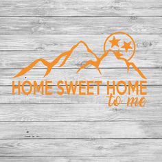 the home sweet home to me decal is shown on a wooden background with mountains and stars