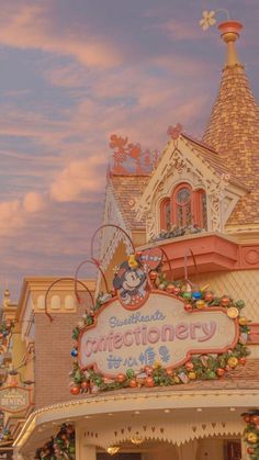 the front entrance to disneyland's constructionary with decorations and lights on display at dusk