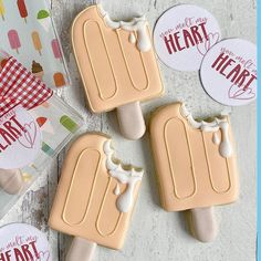 three ice cream popsicles sitting on top of a table