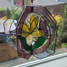 a stained glass flower hanging from a window