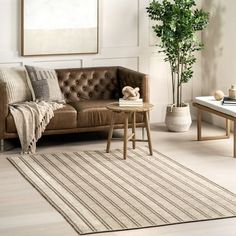 a living room filled with furniture and a rug