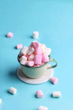 small marshmallows in a cup on a blue background