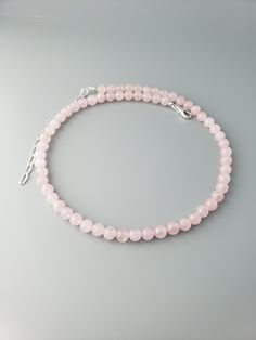 "This  round smooth Madagascar Rose Quartz beads are about 6mm.  The length is 16\" plus 3\" extension.  Sterling silver chain and lobster clasp.  Madagascan Rose Quartz is a rare, classic 'rose' pink gemstone from Madagascar's Antananarivo Province. A romantic gemstone historically known as the 'gem of love' is noted for its superior quality.  Link to the shop  https://www.etsy.com/shop/CrystalRise" Pink Round Necklace With Lobster Clasp, Elegant Rose Quartz Round Crystal Necklaces, Elegant Rose Quartz Round Bead Necklace, Elegant Rose Quartz Round Crystal Necklace, Elegant Pink Necklaces With 8mm Beads, Elegant Round Rose Quartz Crystal Necklace, Rose Quartz Gemstone Beads Necklace, Round Rose Quartz Gemstone Bead Necklaces, Round Rose Quartz Gemstone Beads Necklace