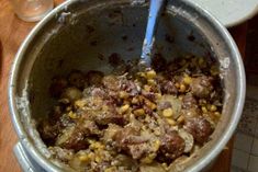 a pot filled with food sitting on top of a wooden table