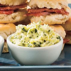 two sandwiches with meat, lettuce and sauces on the side sitting on a plate